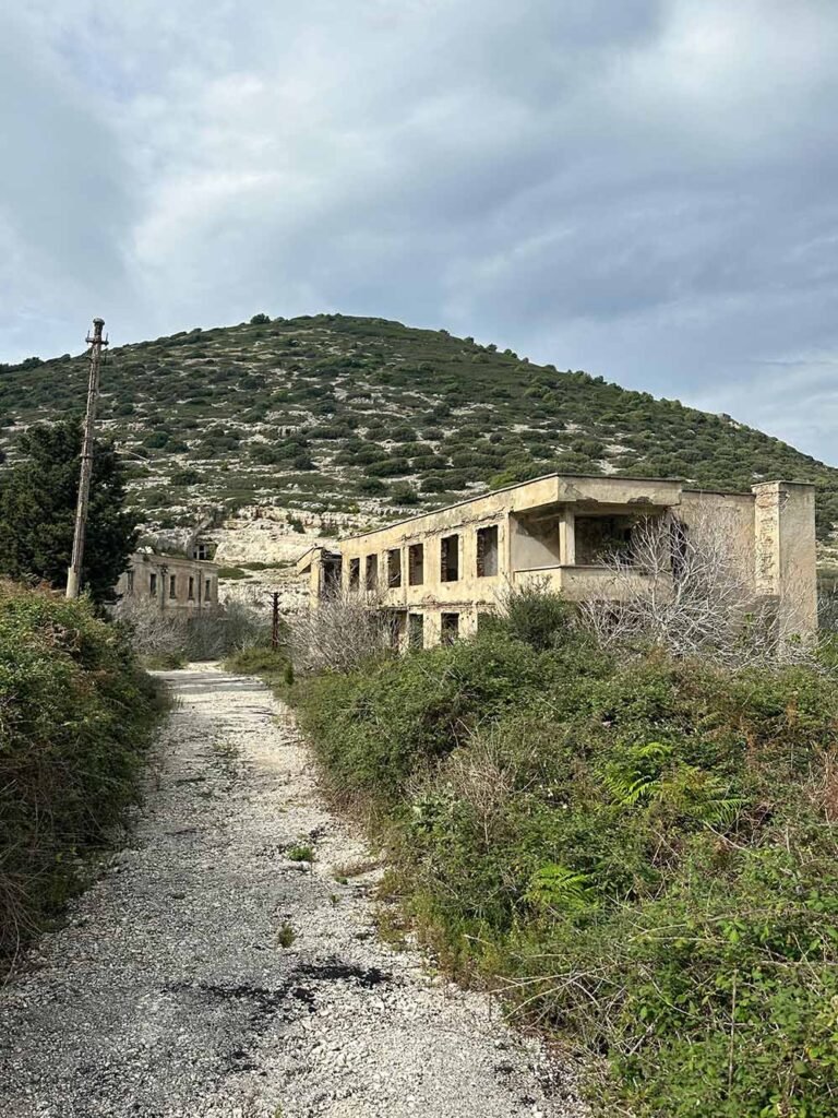 vIEW OF A PATH WITH ABANDONED BUILDINGS IN sAZAN iSLAND, vLORE